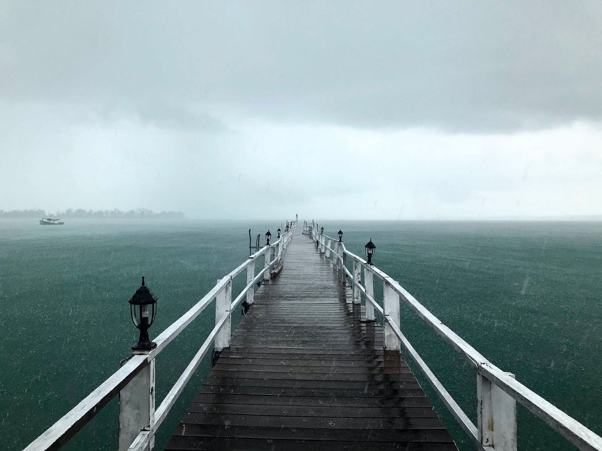 Pier reaching into misty water