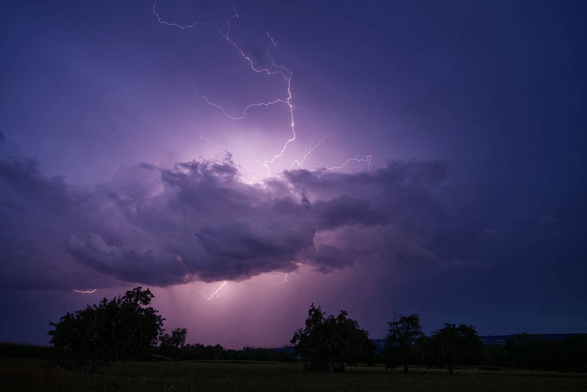 Lightning over a dark coastline