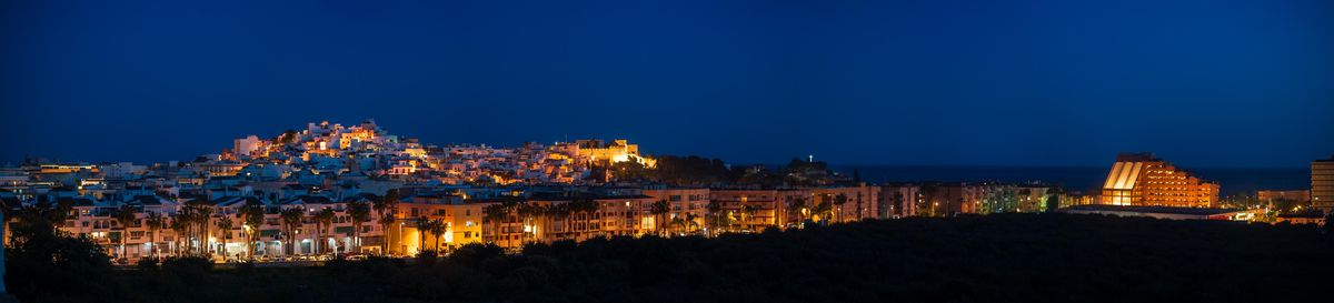 Hillside town glowing at dusk