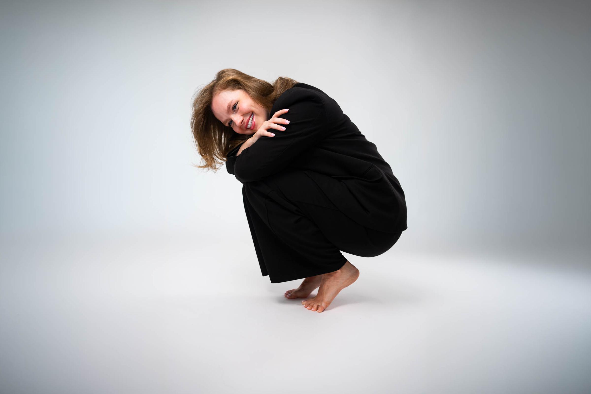 Creative studio portrait of a woman dressed in black
